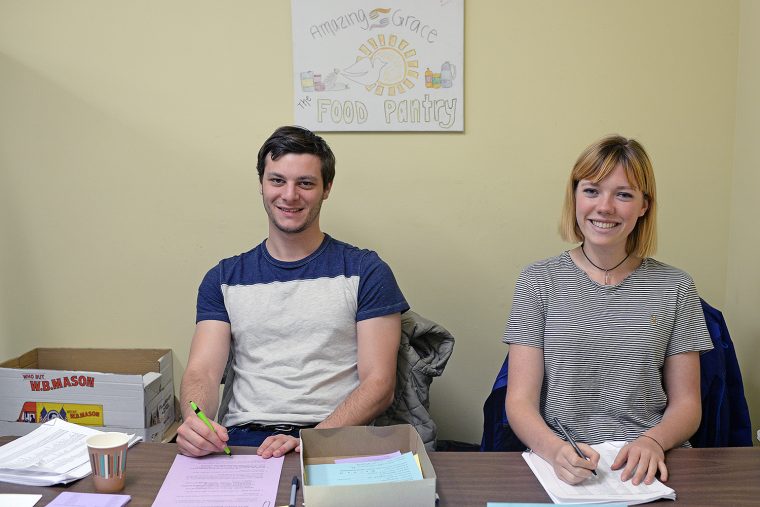 Gabe Weinreb '18 and Celeste Smith '19 help local residents sign up for a free Thanksgiving Day meal.