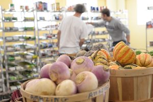 Fred Ayers helps a patron gather a ration of food at Amazing Grace. The pantry serves an estimated 3,000 individuals, or 1, 075 households each month.