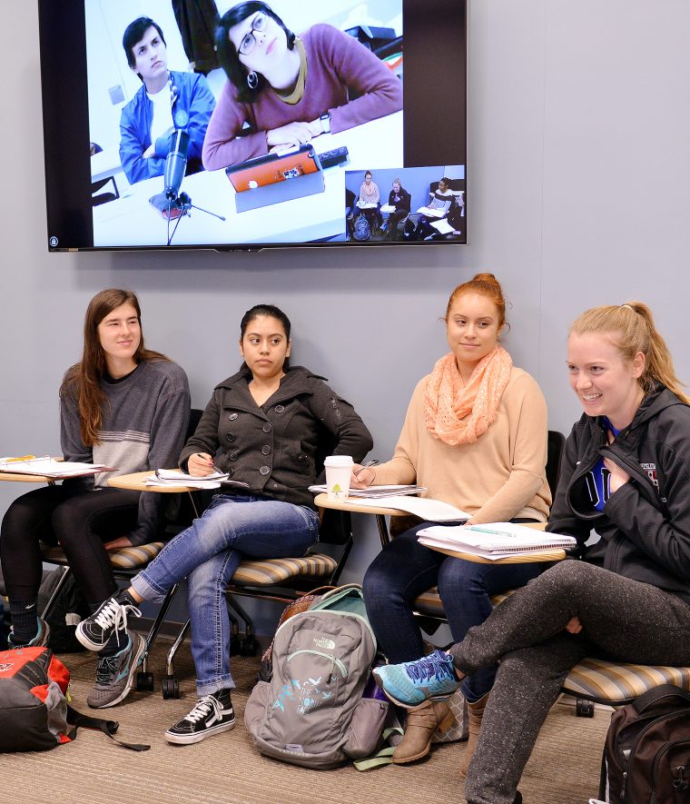 Wesleyan students hold conversations with students in Madrid from the Fisk 101 classroom. 