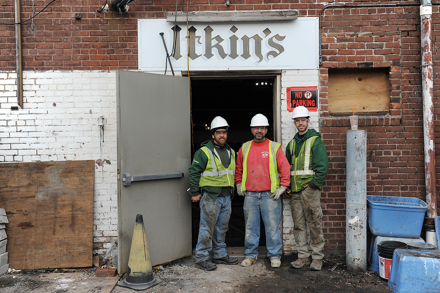 Contractors gather near the old Itkin building's rear door on Feb. 22. 