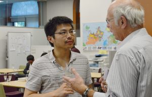 Don Moon, at right, speaks with graduate student Andrew Dingzhong Sun during the Wesleyan University — Social Sciences in China Press Forum on Globalization on May 18. 