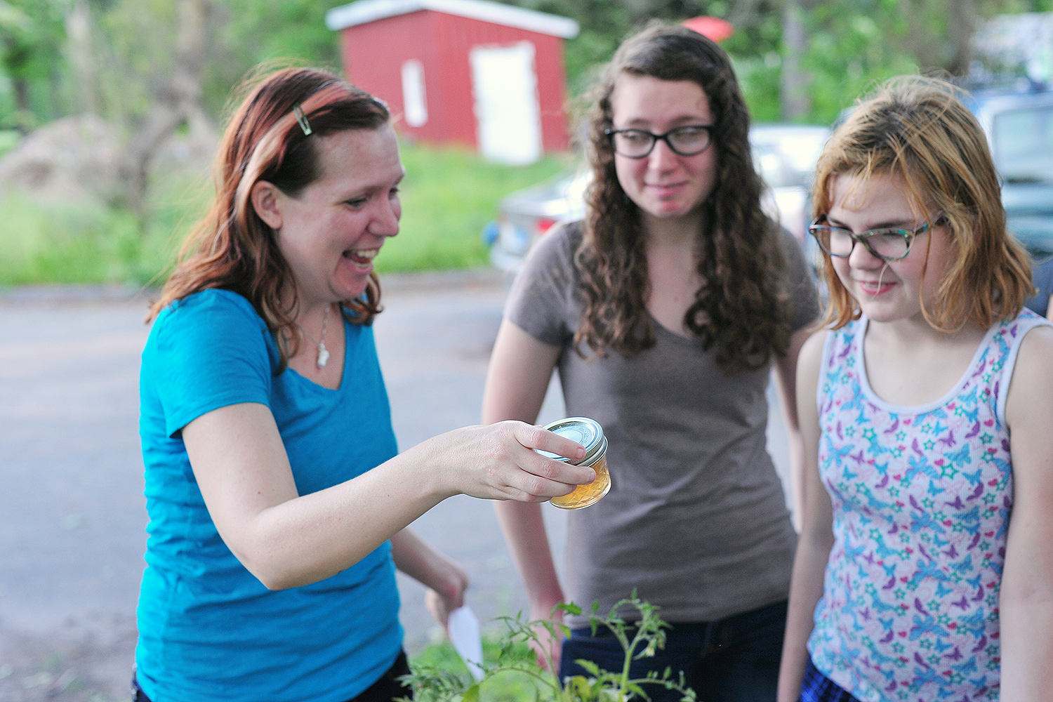 Anika Dane, administrative assistant for the Molecular Biology and Biochemistry Department, shops for dandelion jelly with her daughters, Kerste and Aeris. "Aeris confirms the jelly tastes like honey," Dane said. 