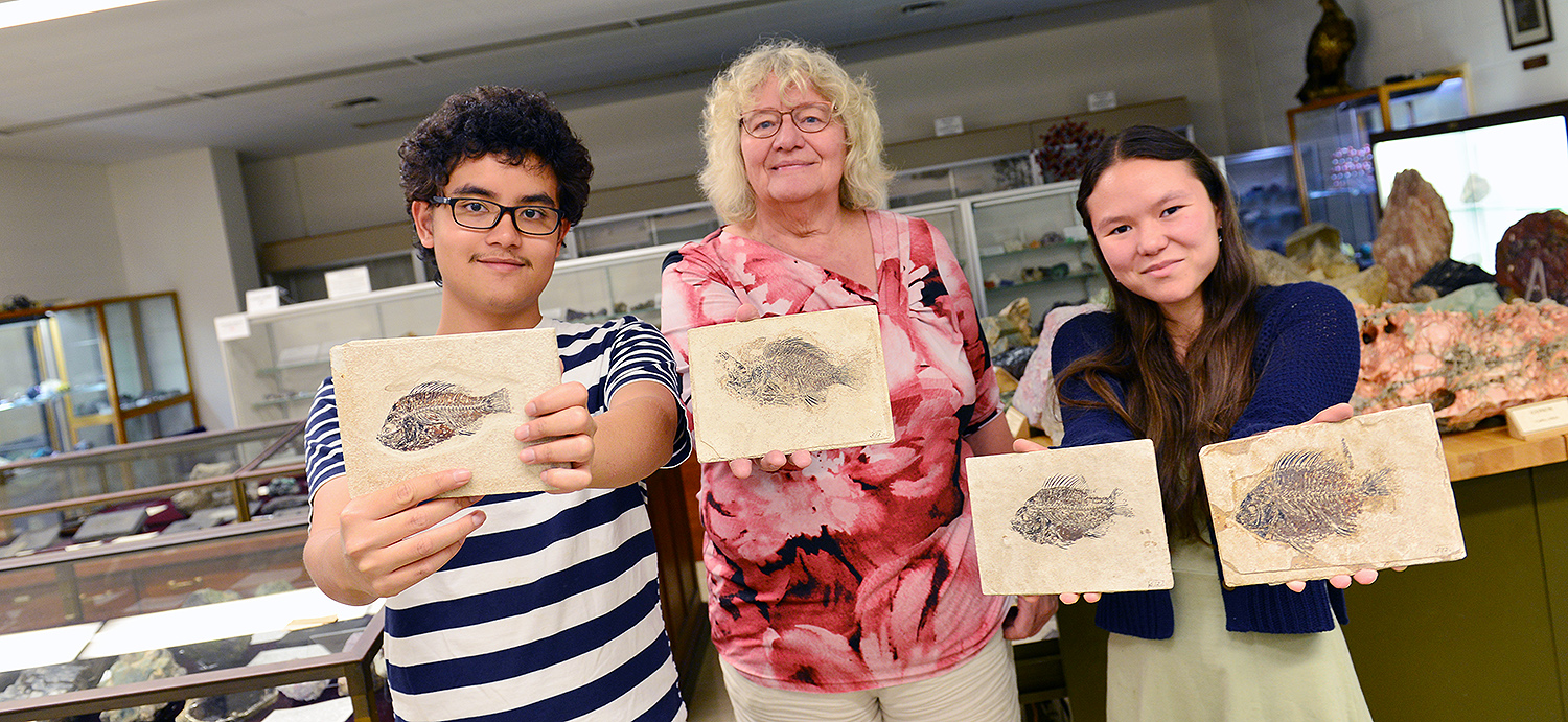 Sanjirat "Bright" Palakarn '20; Ellen Thomas; and graduate student Melissa McKee '17 hold fish fossils inside the Joe Peoples' Museum in Exley. 