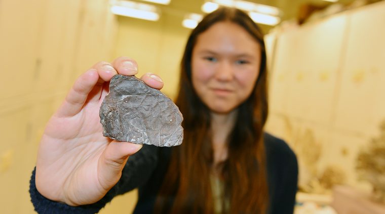 Melissa McKee holds a plant fossil from Greenland, collected during the second relief expedition for a Peary Arctic Expedition. The leaves were then thought be by Miocene (~20 millions years old), but now they've been identified as being much older at ~ 60 million years.