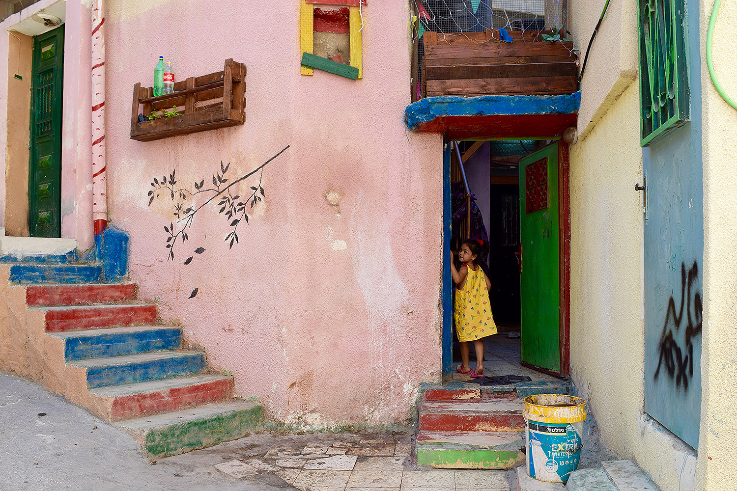 Aida” by Isabel Steckel, ‘19; Bethlehem, Palestine “A little girl in yellow looks back and smiles at me before entering her family's house at the Aida Refugee Camp -- home to more than 5,500 Palestinian refugees -- in the central West Bank.”