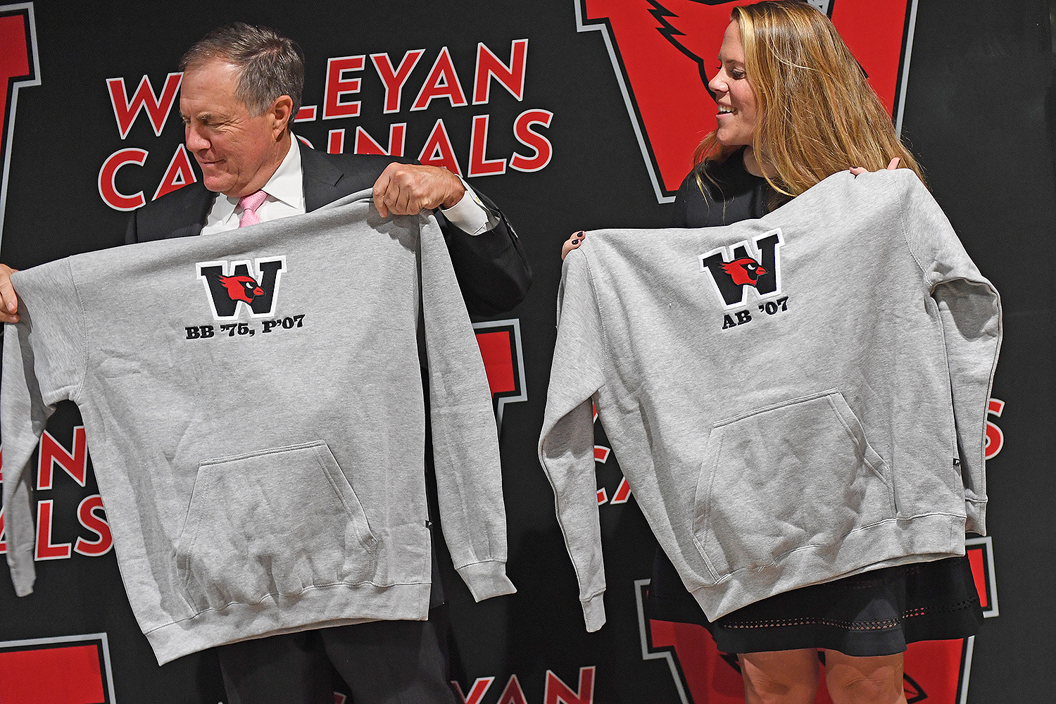 Mike Whalen, the Frank V. Sica Director of Athletics, presented personalized sweatshirts to Bill and Amanda Belichick.