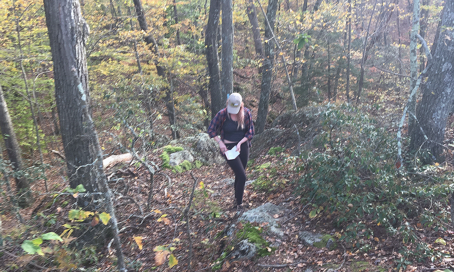 Earth and environmental sciences major Jackie Buskop '19 collects field data along a hiking trail in Connecticut. (Photo by Melissa Luna)