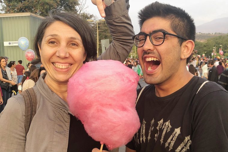Marcela Oteíza, assistant professor theater, and Ryan Dobrin '18 snack on cotton candy prior to the "Beringei" production at the Festival Internacional Santiago a Mil in Santiago, Chile. Inspired by the name of one of the most threatened species of gorilla in the world, Beringei is a street show of large mechanical puppets that raise awareness of the gorillas' risk of extinction. 