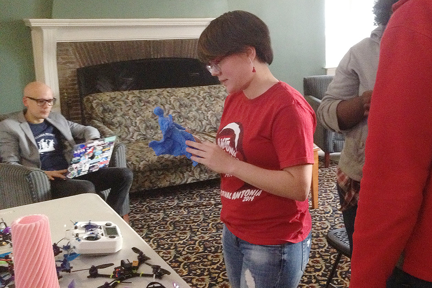 Ana Rodriguez Santory, a visiting student from Puerto Rico, examines a scaled 3-D print of a sculpture. 