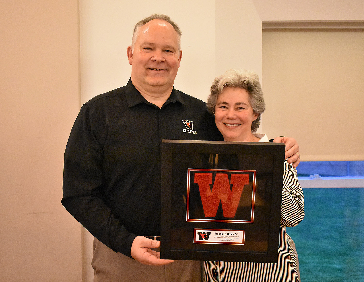 Francine Rivkin '78 was honored with the Cardinal Award, the Athletic Advisory Council's recognition of extraordinary contributions and dedication to the success of the Wesleyan Athlete Program. Rivkin is pictured with Mike Whalen, the Frank V. Sica Director of Athletics and chair of Physical Education, at left.