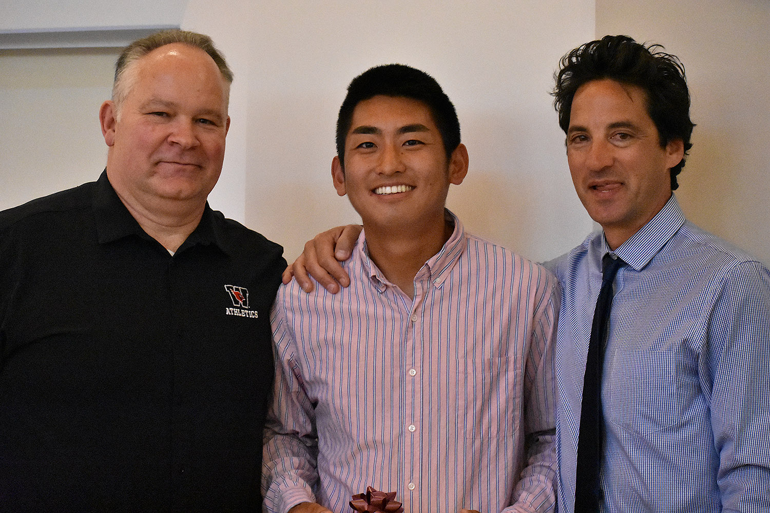 Tennis player Steven Chen '18 received the Maynard Award, which recognizes the top senior male and female scholar-athletes at the university. He is pictured with Whalen, left, and Mike Fried, head tennis coach, right. Along with Julie McDonald '18, Chen was also chosen by the administration to speak on behalf of student-athletes.