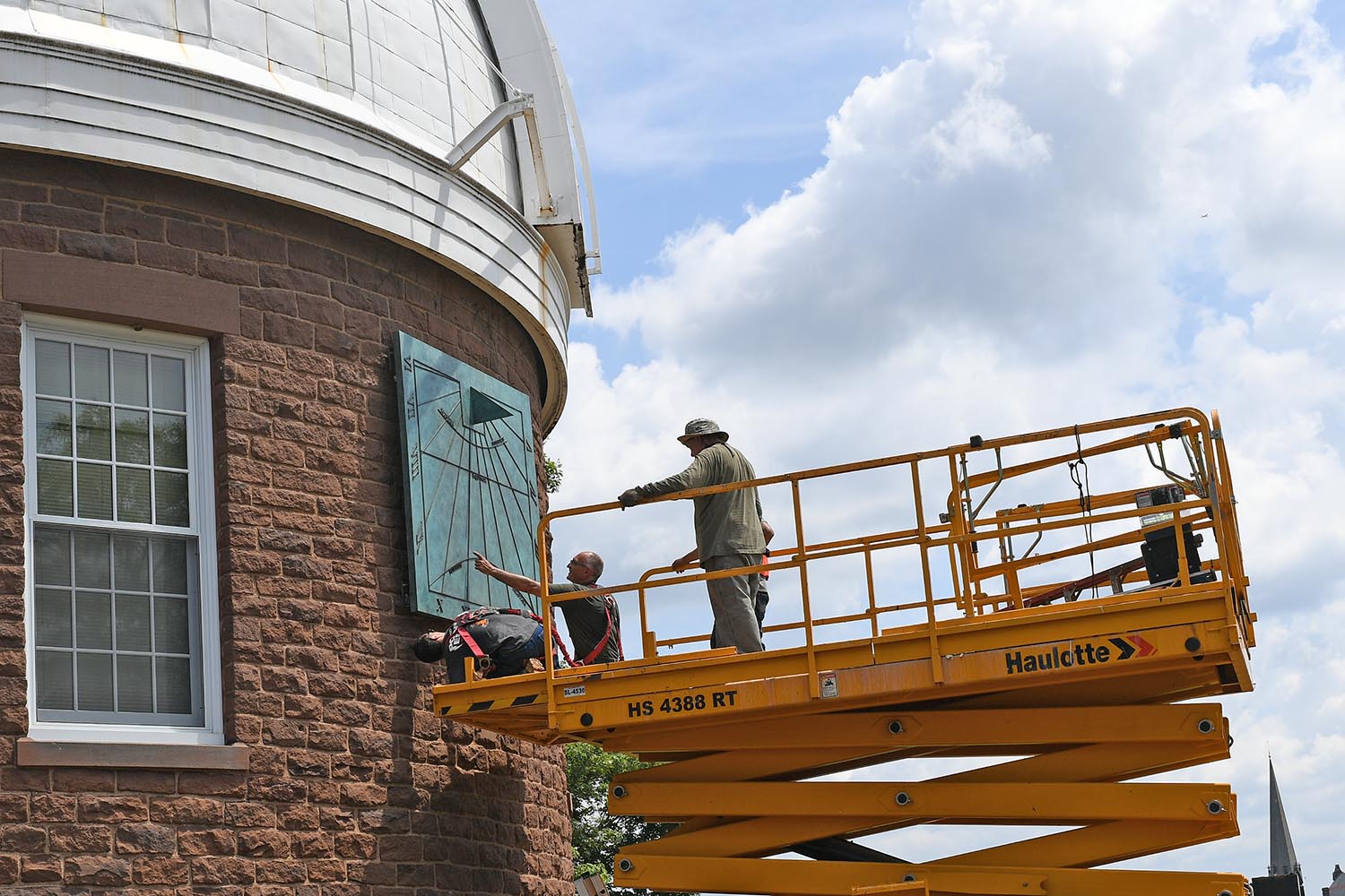 Adzema chose to color the bronze sculpture in a patina. "I chose this green because it is the natural color bronze would oxidize over time. It is also a green that looks great against the color of the Observatory's brownstone walls,"