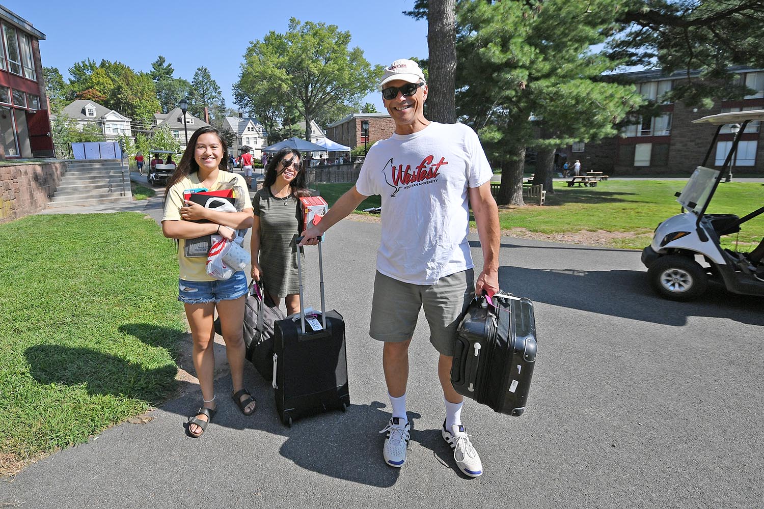 Wesleyan President Michael Roth '78 helps a student move into her residence in the Butterfields. 