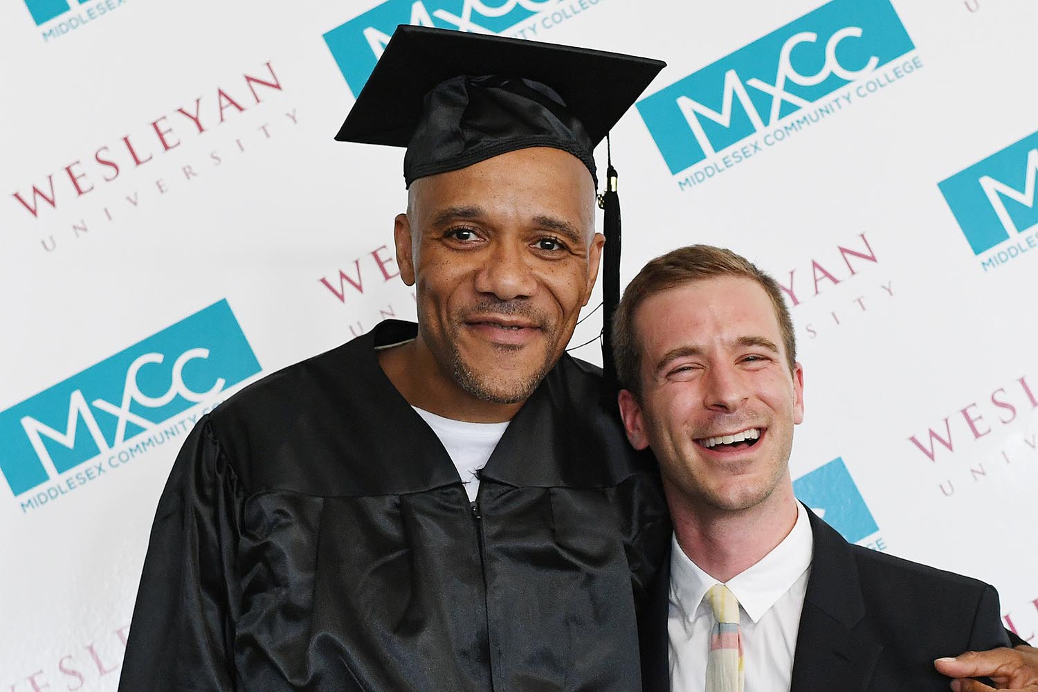 Inmate Clyde shares a hug with Russell Perkins '09, who led a seminar on literature and philosophy at Cheshire Correctional Institution as a student. 