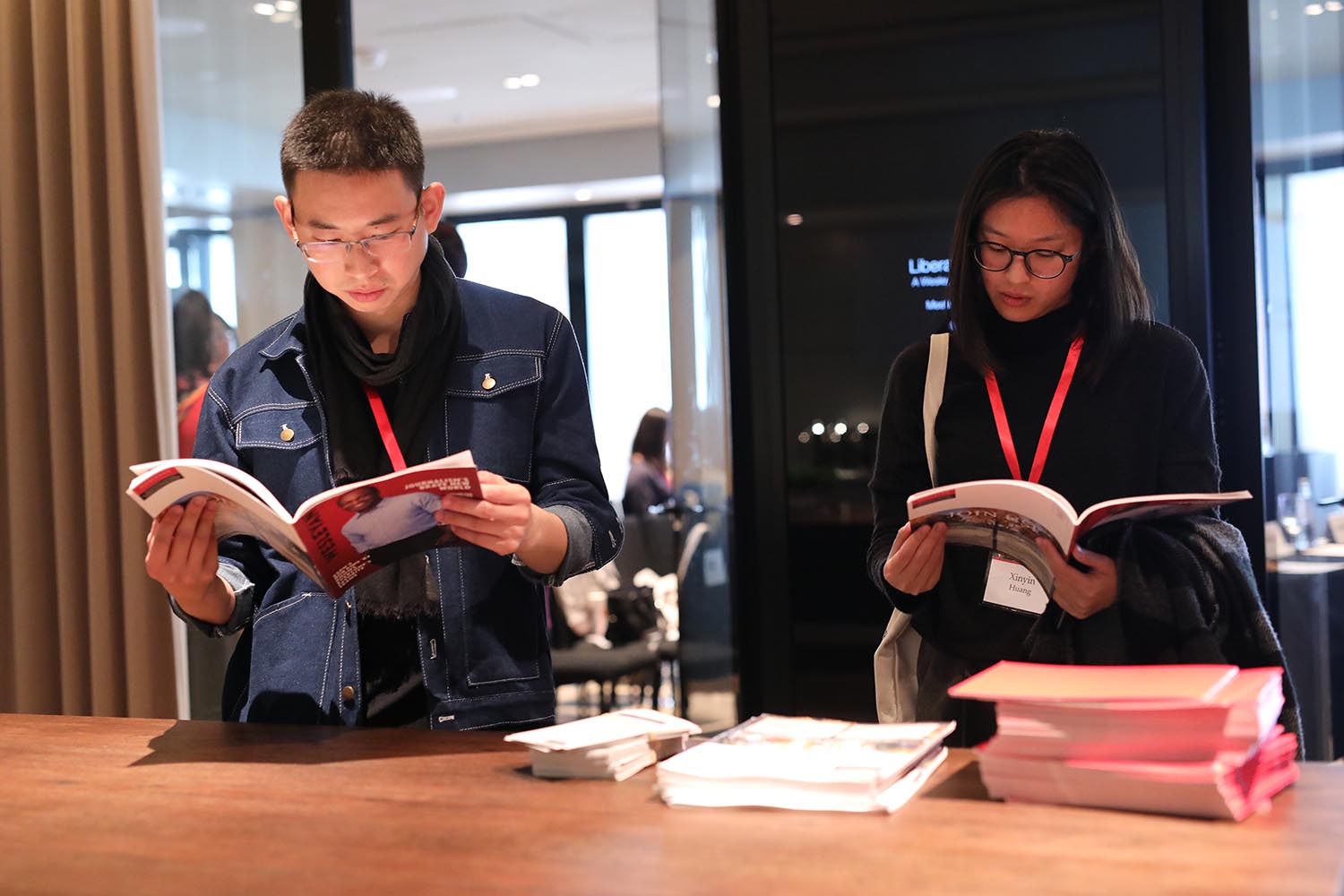 Attendees peruse the latest issue of Wesleyan magazine.