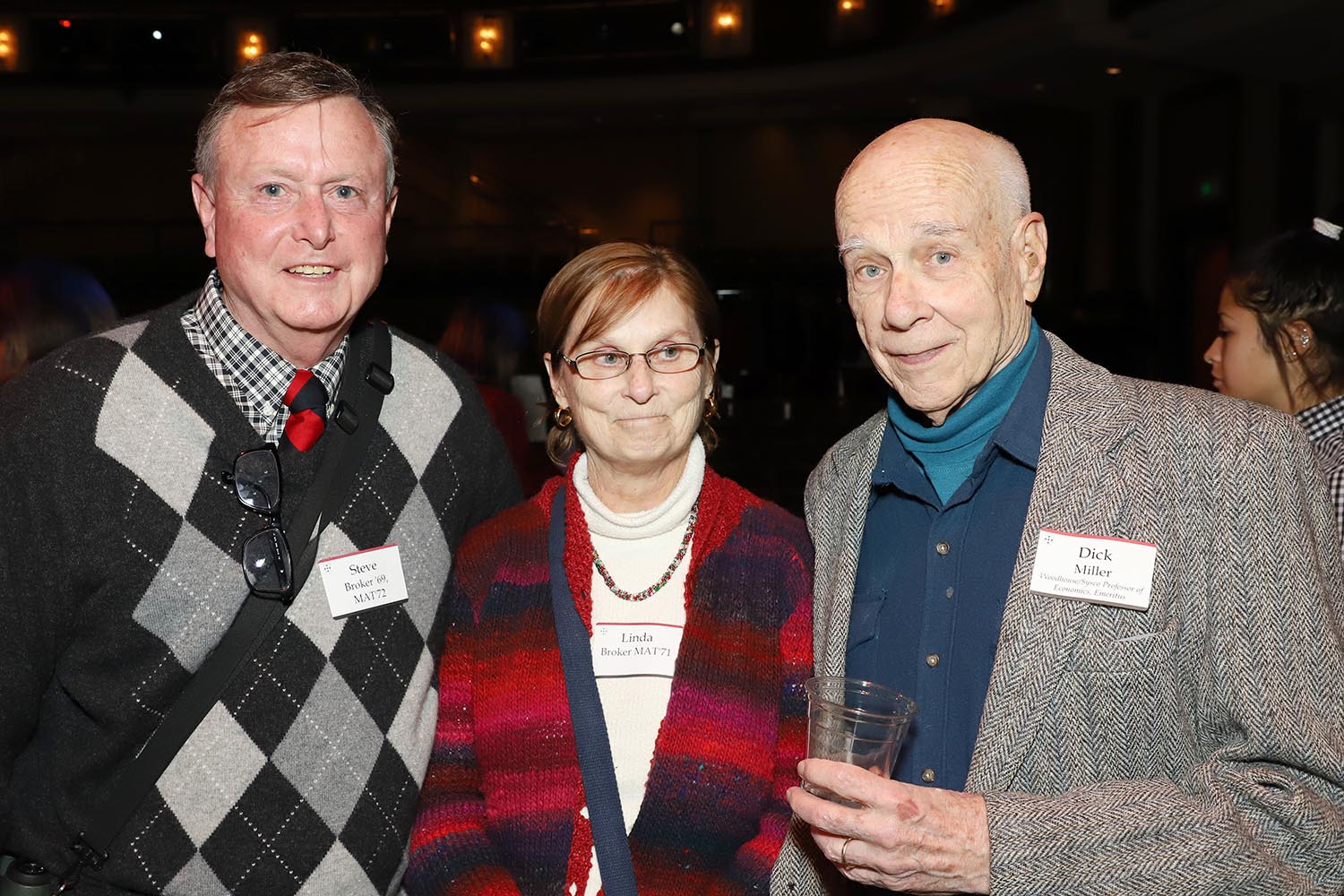 From left, Steve Broker '69, MAT '72, Linda Broker MAT '71, and Dick Miller, the Woodhouse/Sysco Professor of Economics, Emeritus.