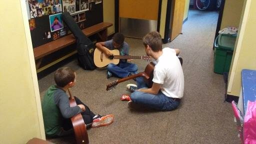 Musical Mentor Henry Hodder ‘20 works with two of his guitar students at Oddfellows Playhouse in Middletown. 