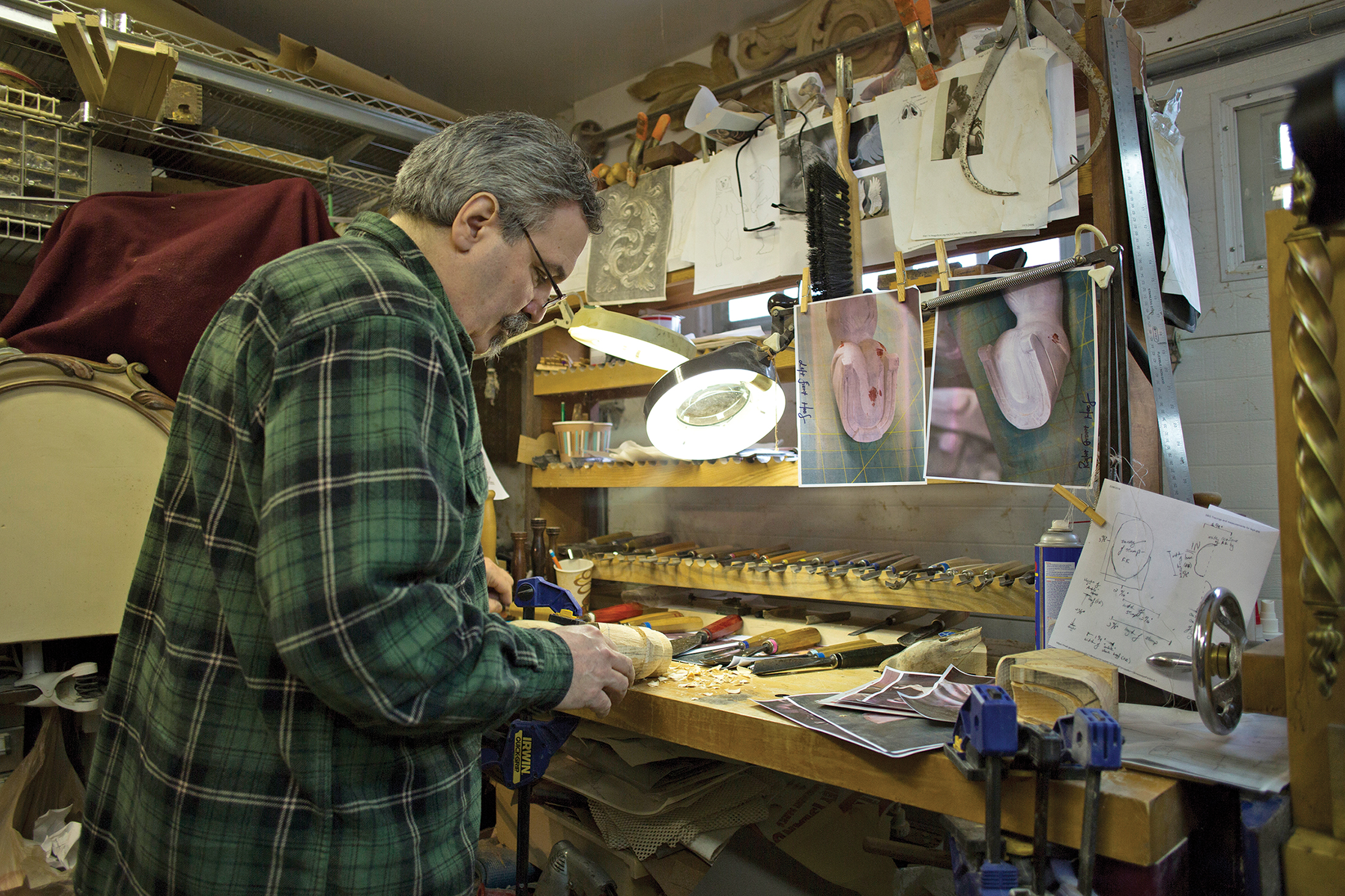In his workshop, he carves a new leg and hoof for an antique carousel horse. (Photo by Melissa Rocha)