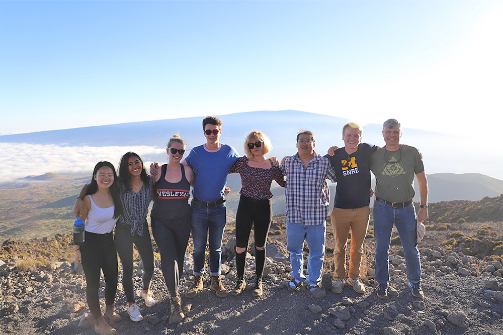 Left to right: Kelly Lam, Sara Wallace-Lee, Jacqueline Buskop, John Sheffer, Celeste Smith, Tim Ku, Ryan Nelson, and Phil Resor. Photo taken at in January 2019 atop Mauna Kea at >10,000 feet above mean sea level with Mauna Loa in the background.