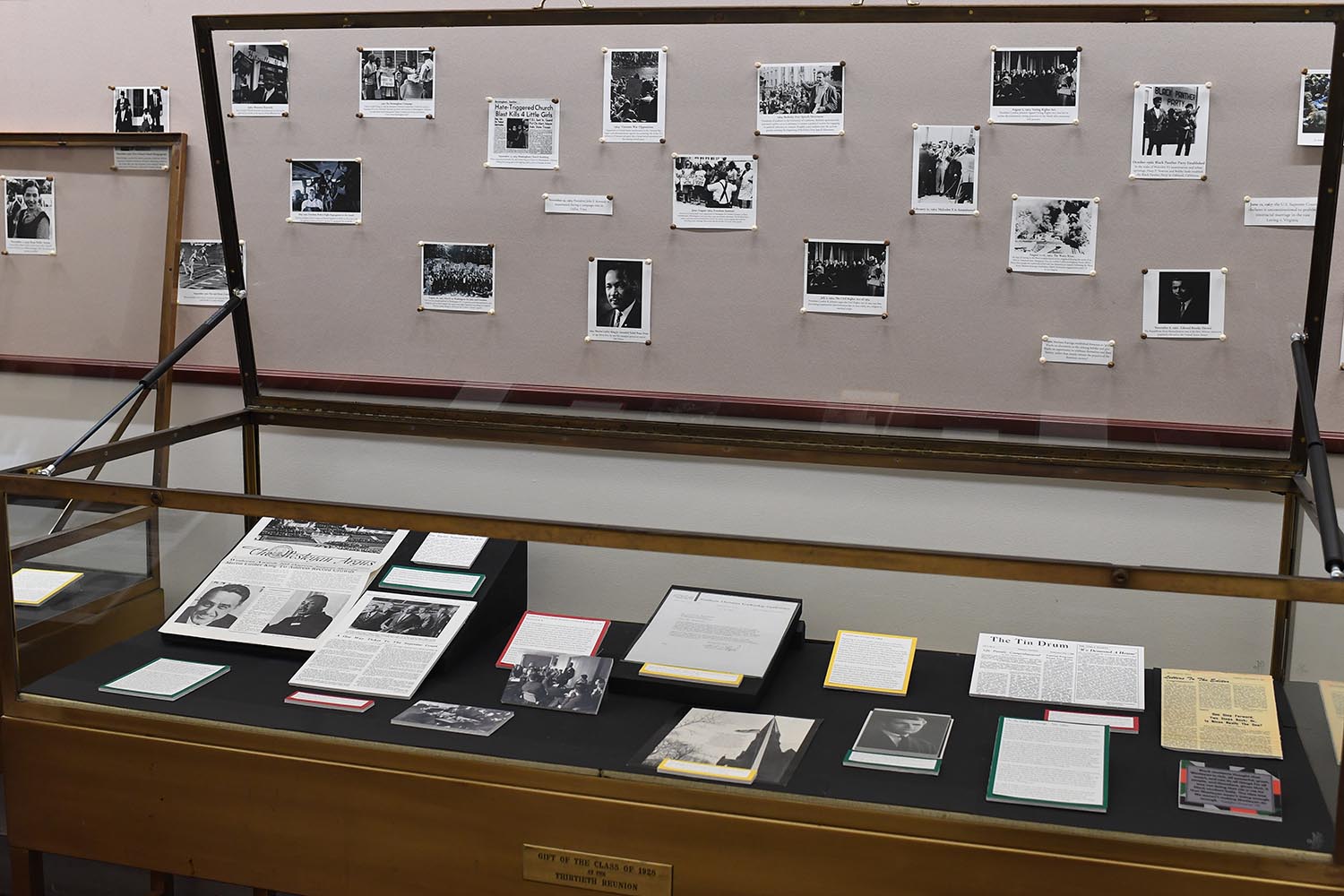 An exhibit titled "Through the Lens of History: The Wesleyan African American Experience" is on display in Olin Library outside Special Collections & Archives. 