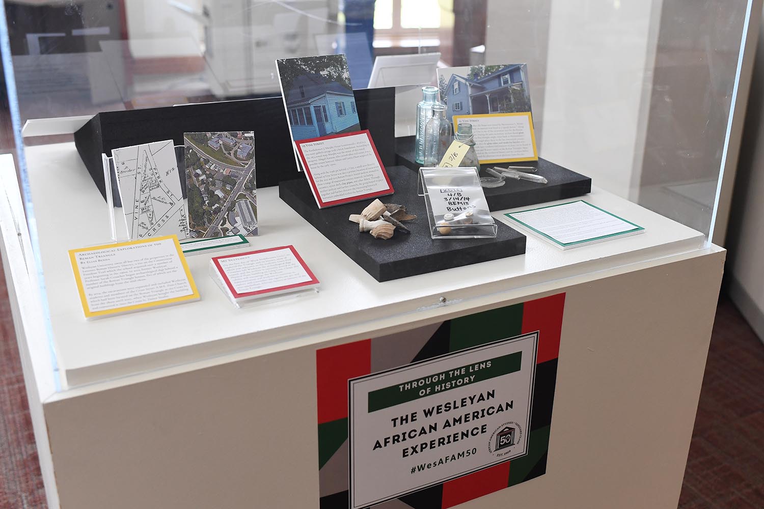 Student-curated mini-exhibits are displayed inside cubed-cases in the Olin Reading Room. Pictured is a display titled "Unburying Black Middletown History: Archaeological Findings From the Beman Triangle.” curated by Arianne Philemy '21. 