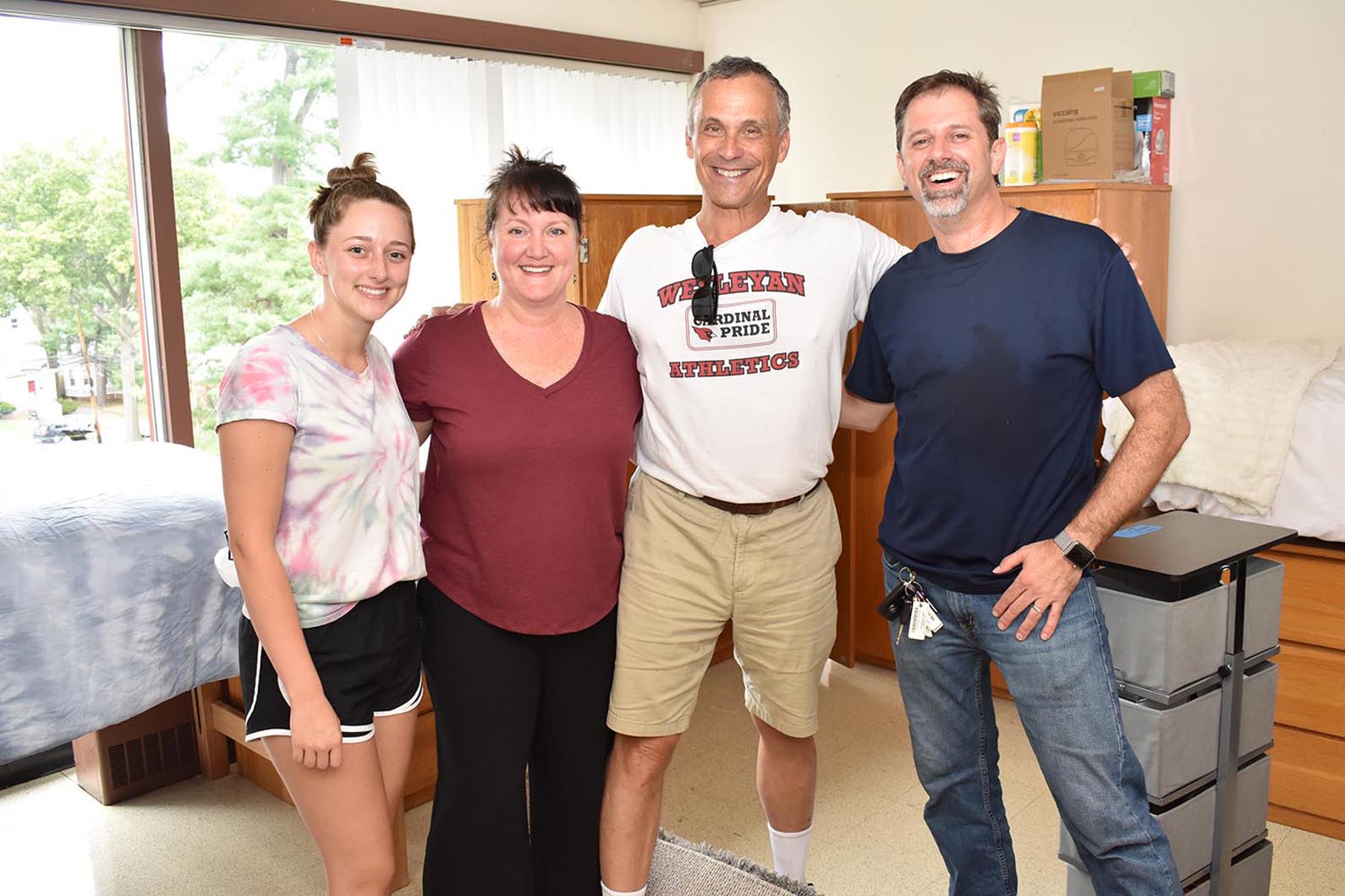 At left, Emma Winslow Horwitz '23 from Lexington, Mass poses with her mother Aiden, President Roth, and her father Russell. Horwitz is the great-granddaughter of Dick Winslow '40, Hon'10, P'71, GP'23. Winslow was the John Spencer Camp Professor of Music emeritus who oversaw the establishment of Wesleyan University’s renowned program in world music. The university has since established the Richard K. Winslow Chair in Music.