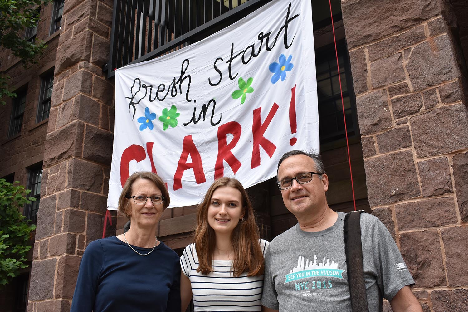 0134 Hannah Gonsher photographed with parents in front of Clark Hall sign (Cynthia might have more details)