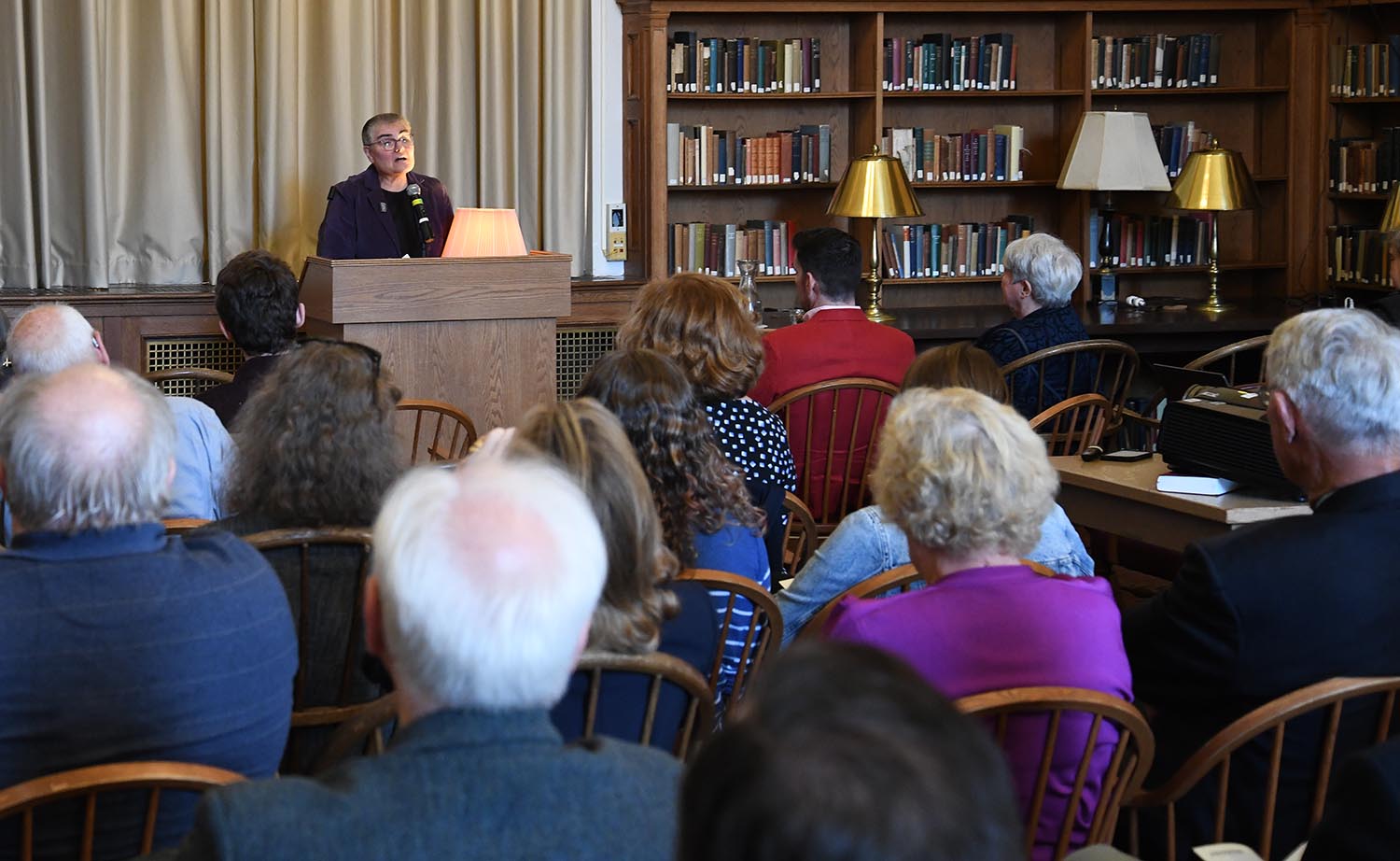 Director of Special Collections Suzy Taraba ’77 MALS ’10 addresses those in Smith Reading Room from the podium 