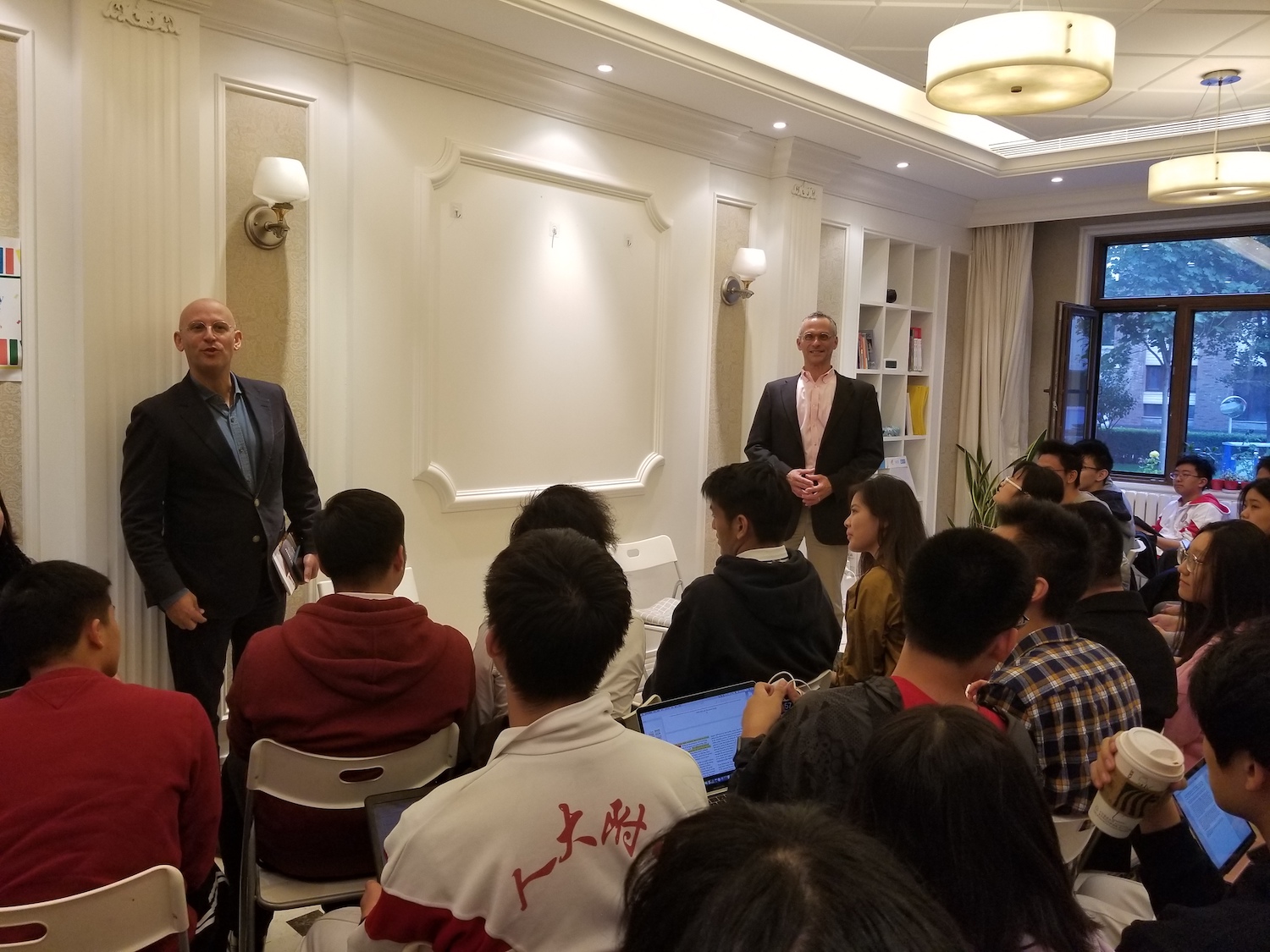 Rothschild, left, and Roth, right, speak to prospective students at Elite Scholars of China.