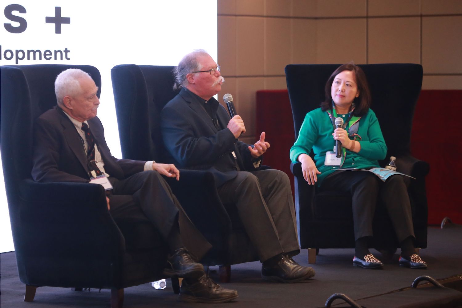 At the second annual Liberal Arts + forum in Beijing on Oct. 19, from left, Richard Adelstein, the Woodhouse/Sysco Professor of Economics, and Barry Chernoff, the Robert Schumann Professor of Environmental Studies, spoke on a panel moderated by Julia Zhu '91 about Wesleyan's unique interdisciplinary approach to teaching economics and environmental studies.