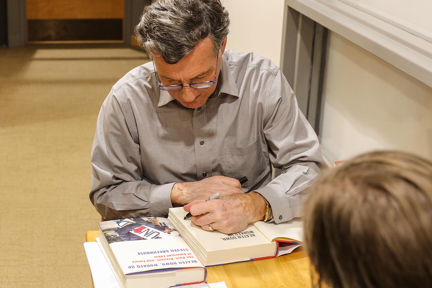 Steven Greenhouse signs copies of his book.