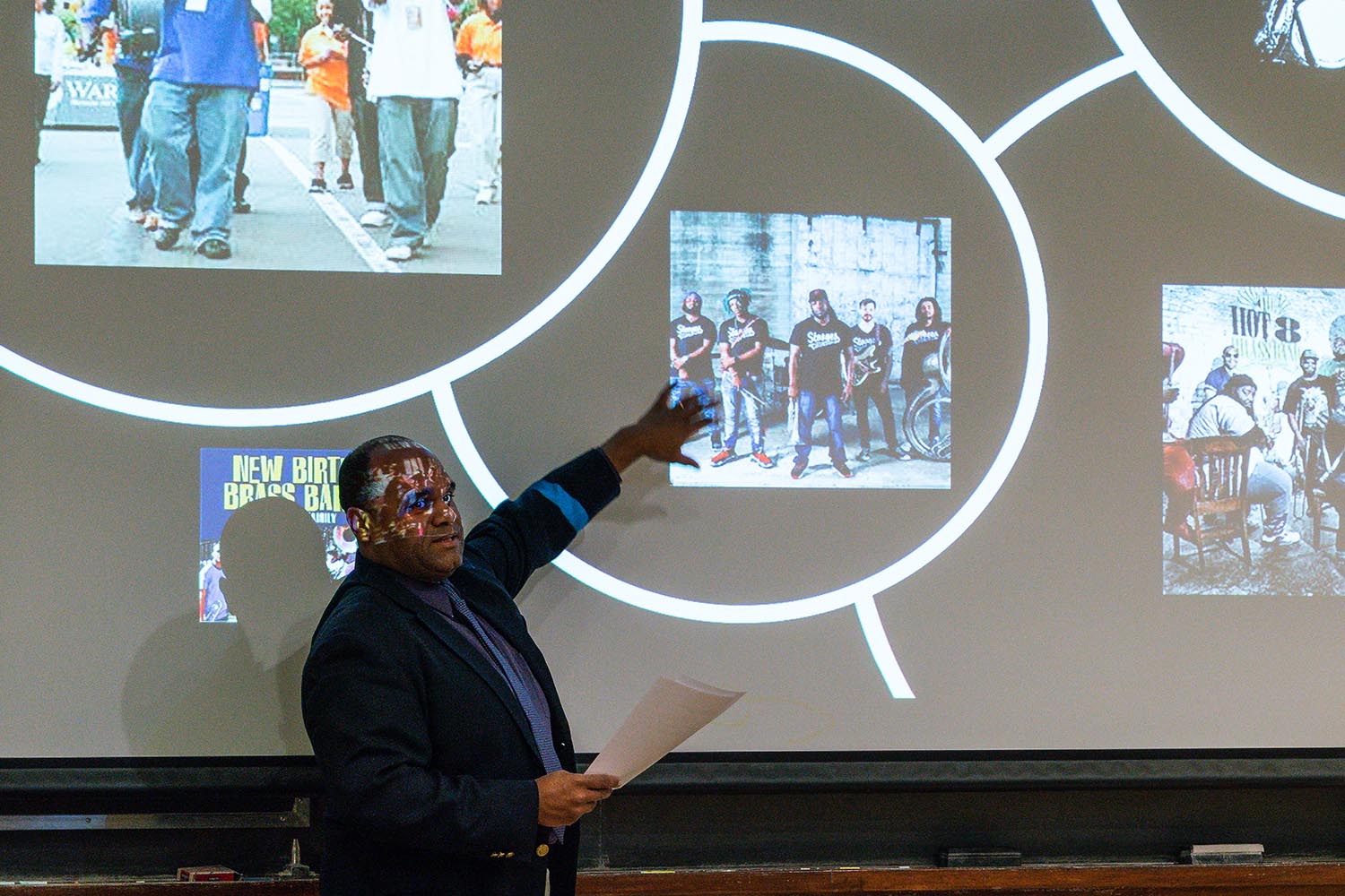 McNeil explained how the institution of the Black New Orleans brass band represents a genealogic continuum that extends back to the arrival of the first enslaved Africans to the Louisiana Territory. "This continuum connects a violent past, marked by physical abuse of black bodies in the form of institutionalized slavery, to a violent present confounded by systemic poverty, social injustice, and police brutality," he said. In spite of extreme oppression, the brass band community continues to enrich and enliven both local communities through their iconic musical offerings.
