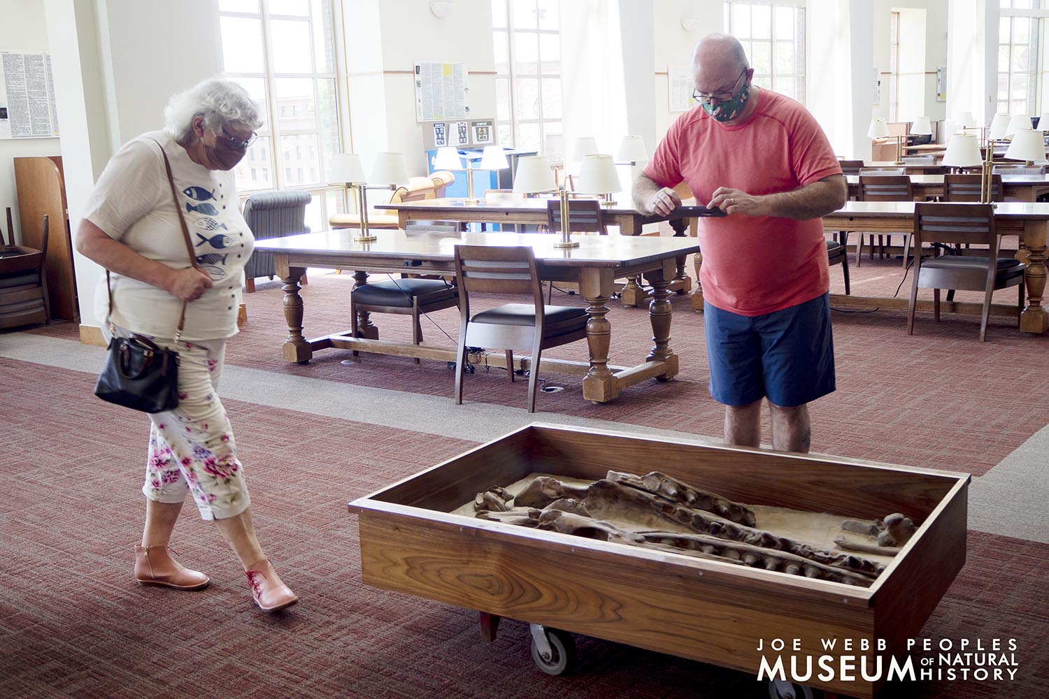 Ellen Thomas and Andrew White examine the cast before installation. 