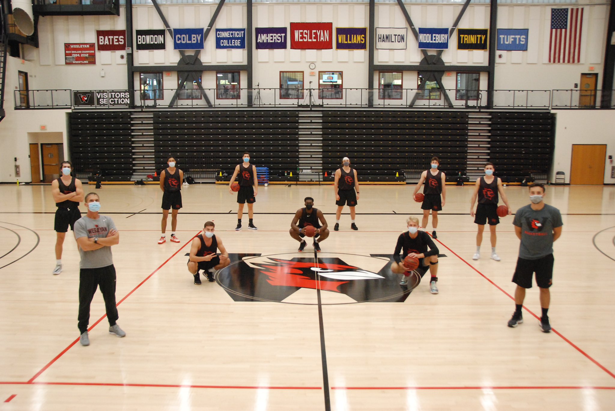 I'm on the far right with my arms crossed. Olu, who is featured in the story, is squatting in dead center. Coach Reilly also has his arms crossed, and is far right in the gray.