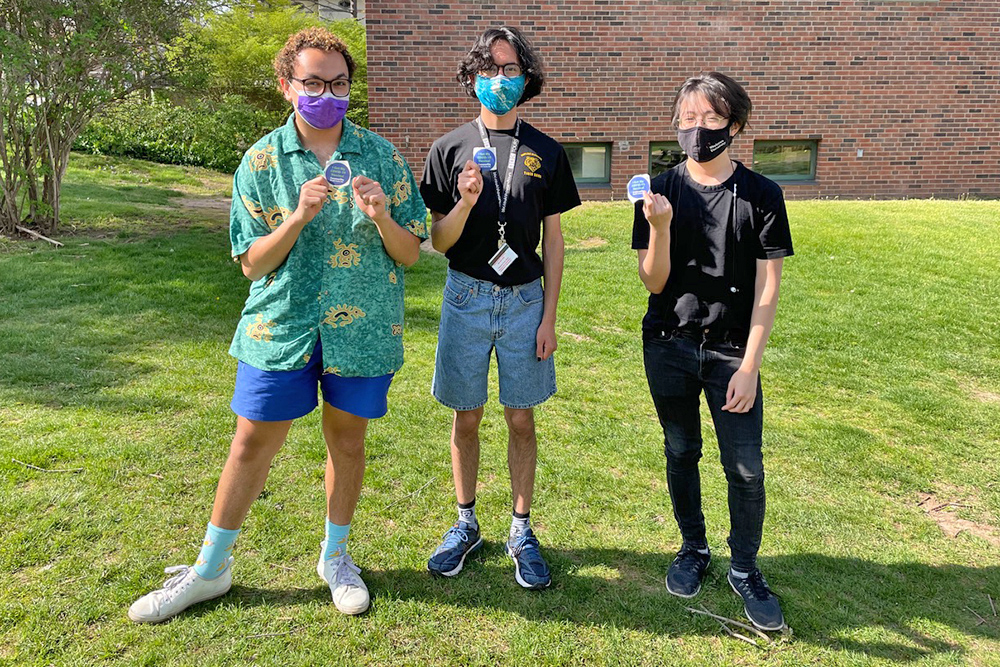 Vincent Langan '24, Andres Angeles-Paredes '24, and Tuong Nguyen '24 proudly display their "I'm vaccinated" stickers after receiving their first Pfizer COVID-19 vaccination on April 24. "I feel elated. This is an emotional high," Langan said. "I am extremely grateful." (Photo by Rachel Wachman '24)