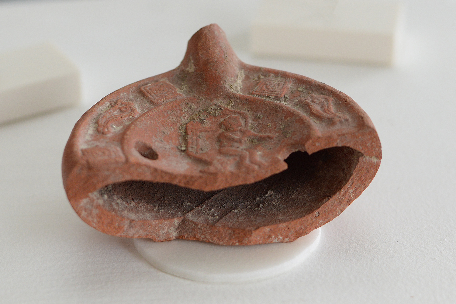 Margaret Sullivan '23 examined a ceramic North African oil lamp from the 4th or 5th century CE. "This mold-made lamp has a shallow, bulbous base. Two fill holes puncture the lamp's fracture top, which is adorned with alternating square and fish-like motifs, all surrounding a seated musician figure. This central image of music-making illustrated pleasurable, secular activities," she explained.  